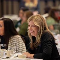 people laughing at luncheon table